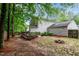 Large backyard showcasing a wooden deck, a fire pit, and plenty of room for outdoor activities at 5410 Pageford Dr, Durham, NC 27703
