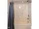 Bathroom shower featuring a built-in seat and gray shower curtain at 5410 Pageford Dr, Durham, NC 27703