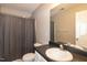 Bathroom featuring a toilet, mirror, vanity and shower with curtain at 5410 Pageford Dr, Durham, NC 27703