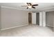 Bedroom with neutral carpet, ceiling fan, closet, and doorways at 5410 Pageford Dr, Durham, NC 27703