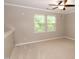 Bonus room with neutral carpet, ceiling fan, and natural light at 5410 Pageford Dr, Durham, NC 27703