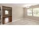 Well-lit dining area with tile flooring and a view of the backyard through large windows at 5410 Pageford Dr, Durham, NC 27703