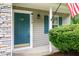 The front door with a no soliciting sign is framed by stone accents, shutters, and manicured bushes at 5410 Pageford Dr, Durham, NC 27703