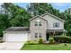Charming two-story home with stone accents, blue shutters, and a well-manicured front yard at 5410 Pageford Dr, Durham, NC 27703