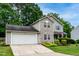 Charming two-story home with stone accents, blue shutters, and a well-manicured front yard at 5410 Pageford Dr, Durham, NC 27703