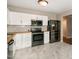 Modern kitchen featuring white cabinets, black appliances, butcher block counters, and elegant flooring at 5410 Pageford Dr, Durham, NC 27703