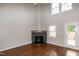 Spacious living room featuring a stone fireplace, tall ceiling, and access to an outdoor deck at 5410 Pageford Dr, Durham, NC 27703