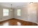 Bright living room with hardwood floors, neutral walls, and natural light from two large windows at 5410 Pageford Dr, Durham, NC 27703