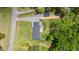 An aerial view of the home, showcasing its new roof, deck, fenced yard, outbuilding, landscaping and long driveway at 553 Isley Rd, Haw River, NC 27258