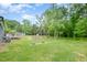 Large backyard featuring a wooden deck and surrounding trees at 553 Isley Rd, Haw River, NC 27258