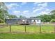 Spacious backyard with a wood fence and partial view of the house at 553 Isley Rd, Haw River, NC 27258