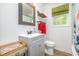 Well-lit bathroom featuring a gray vanity and framed mirror with a bright window at 553 Isley Rd, Haw River, NC 27258