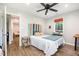 Cozy bedroom featuring hardwood floors, a ceiling fan, and a bright window at 553 Isley Rd, Haw River, NC 27258
