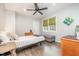 Comfortable bedroom with hardwood floors, ceiling fan, a bed, and a gray ottoman at 553 Isley Rd, Haw River, NC 27258