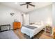 Bright bedroom with wood floors, ceiling fan, a bed, and a dresser at 553 Isley Rd, Haw River, NC 27258