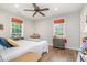Cozy bedroom with wood floors, two windows, and soft lighting, creating a comfortable and inviting space at 553 Isley Rd, Haw River, NC 27258