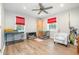Spacious bonus room with hardwood floors, ceiling fan, and natural light from windows at 553 Isley Rd, Haw River, NC 27258