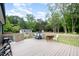 Spacious wooden deck with a table, chairs, grill, and views of a grassy yard at 553 Isley Rd, Haw River, NC 27258