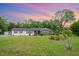 Charming single story home featuring flower beds, a well maintained lawn, and a private treed lot at 553 Isley Rd, Haw River, NC 27258