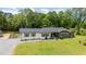 Charming single-story home with a landscaped front yard and detached garage viewed from the air at 553 Isley Rd, Haw River, NC 27258