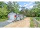 Detached garage with a roll-up door and parking area at 553 Isley Rd, Haw River, NC 27258