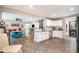 Open concept kitchen with white cabinets, stainless steel appliances, and dining area in the background at 553 Isley Rd, Haw River, NC 27258