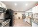 Bright, modern kitchen features stainless steel appliances, white cabinets, and ample counter space for cooking at 553 Isley Rd, Haw River, NC 27258
