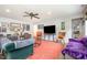 Bright living room featuring comfortable seating, wood floors, and plenty of natural light at 553 Isley Rd, Haw River, NC 27258