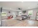 Large main bedroom with a ceiling fan, wood floors, several windows, and space for exercise equipment at 553 Isley Rd, Haw River, NC 27258