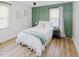 Cozy bedroom with paneled accent wall, windows and hardwood floors create a relaxing and inviting space at 64 Red House Rd, Smithfield, NC 27577