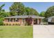Charming one story brick house with mature landscaping and well manicured lawn at 64 Red House Rd, Smithfield, NC 27577