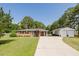 Charming one story brick house with mature landscaping and long driveway leading to a detached garage at 64 Red House Rd, Smithfield, NC 27577