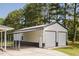Detached garage with an attached carport and a well maintained yard at 64 Red House Rd, Smithfield, NC 27577