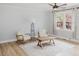 Bright living room featuring fresh paint, luxury vinyl plank flooring, and a ceiling fan at 64 Red House Rd, Smithfield, NC 27577