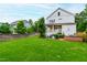 Large, well-maintained backyard with a patio, outdoor kitchen, and ample green space at 729 Mills St, Raleigh, NC 27608