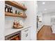 Elegant bar area featuring floating wood shelves and a wine refrigerator at 729 Mills St, Raleigh, NC 27608
