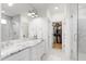 Luxurious Primary bathroom featuring marble countertops, double sinks, modern fixtures, and a large walk-in closet at 729 Mills St, Raleigh, NC 27608