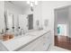 Bright bathroom with double sinks, white cabinetry, and modern fixtures at 729 Mills St, Raleigh, NC 27608