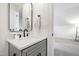 Charming powder room featuring a modern vanity with matte black fixtures and a framed mirror at 729 Mills St, Raleigh, NC 27608