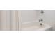 Clean bathroom featuring a white tiled shower and bathtub with a shower curtain at 729 Mills St, Raleigh, NC 27608