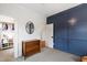Bedroom featuring blue accent wall, dresser, and walk-in closet at 729 Mills St, Raleigh, NC 27608