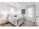 Bright bedroom featuring a black metal bed frame, white linens, and ample natural light at 729 Mills St, Raleigh, NC 27608