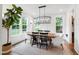 Elegant dining room with a farmhouse table, modern chandelier, and natural light at 729 Mills St, Raleigh, NC 27608