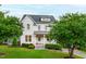 Beautiful two-story home with a manicured lawn, mature trees, and a welcoming front porch at 729 Mills St, Raleigh, NC 27608