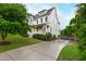 Charming two-story home with white siding, a well-manicured lawn, and a long driveway at 729 Mills St, Raleigh, NC 27608