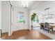 Bright foyer with hardwood floors flows into dining area, featuring modern lighting at 729 Mills St, Raleigh, NC 27608