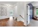 Bright hallway with hardwood floors, white walls, and access to multiple rooms at 729 Mills St, Raleigh, NC 27608