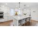 Bright kitchen with large island, pendant lights, and stainless steel appliances at 729 Mills St, Raleigh, NC 27608