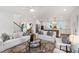 Open-concept layout showcasing living room and modern kitchen with white cabinetry at 729 Mills St, Raleigh, NC 27608