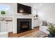 Bright living room with a black marble fireplace and white built-in cabinets at 729 Mills St, Raleigh, NC 27608